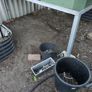 cleared patch of dirt under aquaponics grow bed