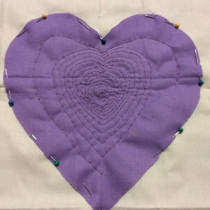 quilting a purple heart onto a green background - front