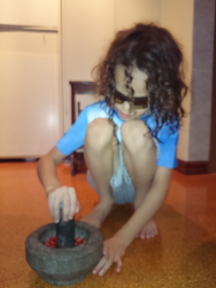 Pounding chilli padi for sambal belacan
