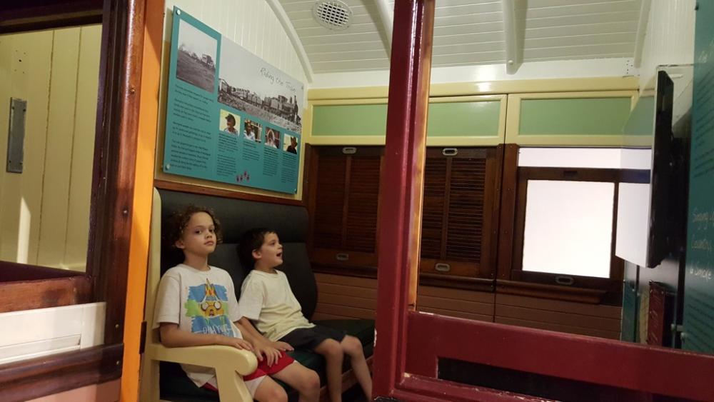 Watching a doco about trains in an old train carriage at the transport museum, Whiteman Park, Western Australia