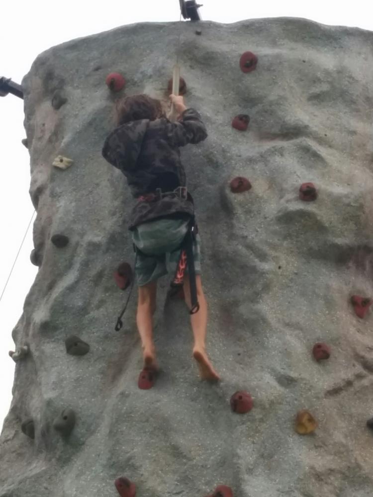 Climbing artificial rock wall at PCYC fundraiser