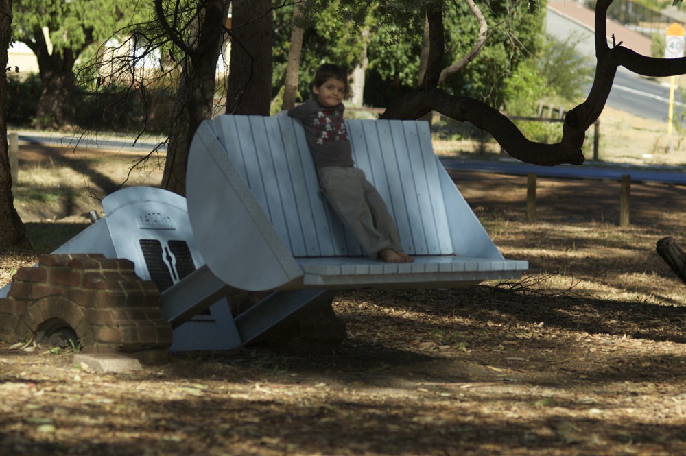 5yo on digger park bench at Mundaring Sculpture Park