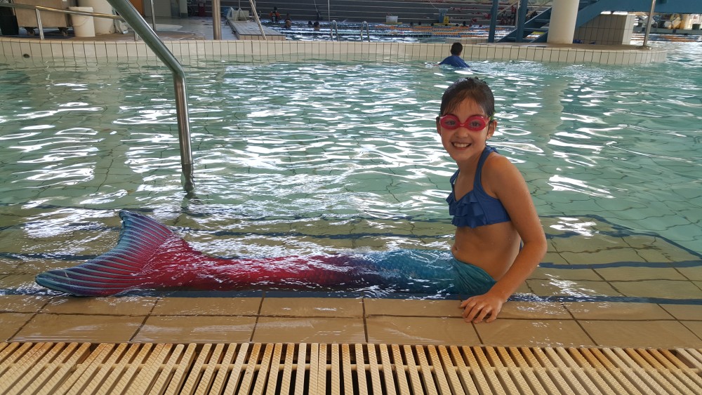 9yo with mermaid tail at the pool
