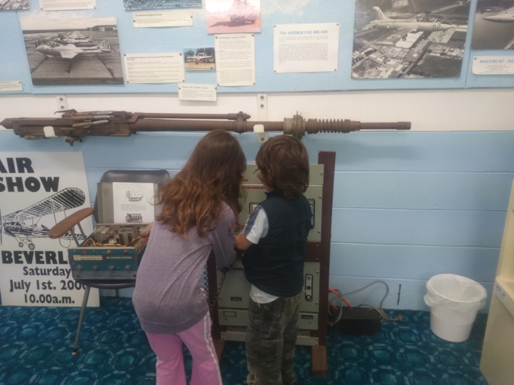 Kids playing with a communication device at the aircraft museum in Beverley, Western Australia