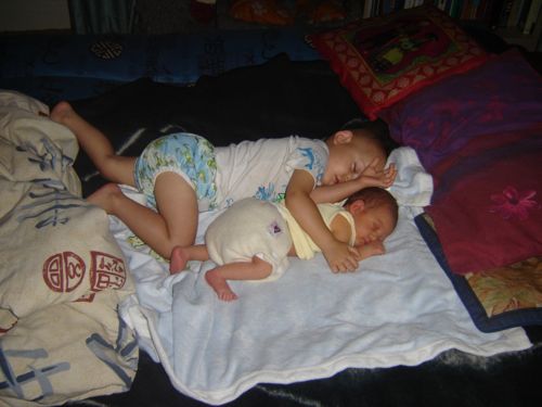 Toddler and baby sleeping cutely