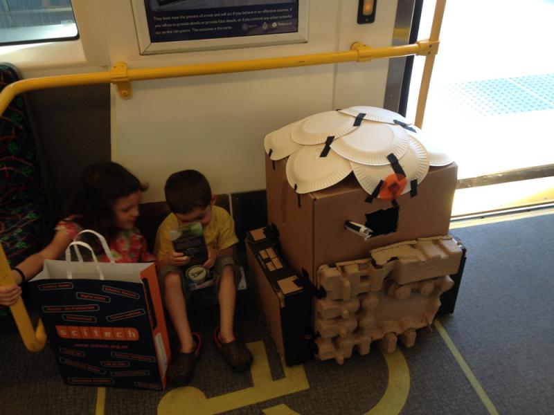 On the train with cardboard R2D2