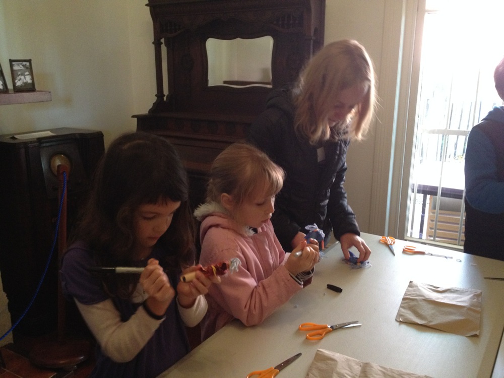 Girls making peg dolls