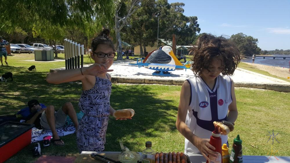 13yo and 11yo grabbing sausage sizzle for lunch, Garret Rd Bridge Park, Western Australia