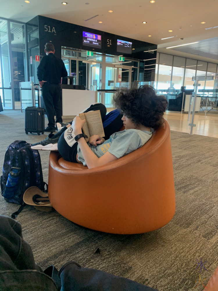 15yo reading in waiting area at Perth Airport, Western Australia