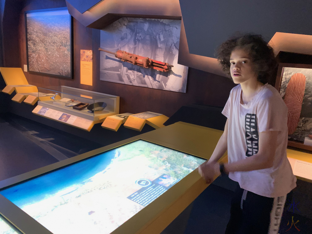 16yo looking at interactive mining map in Boola Bardip Museum, Perth, Western Australia