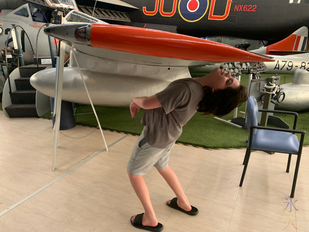 12yo limboing under a plane wing at Aviation Heritage Museum, Bull Creek, Western Australia