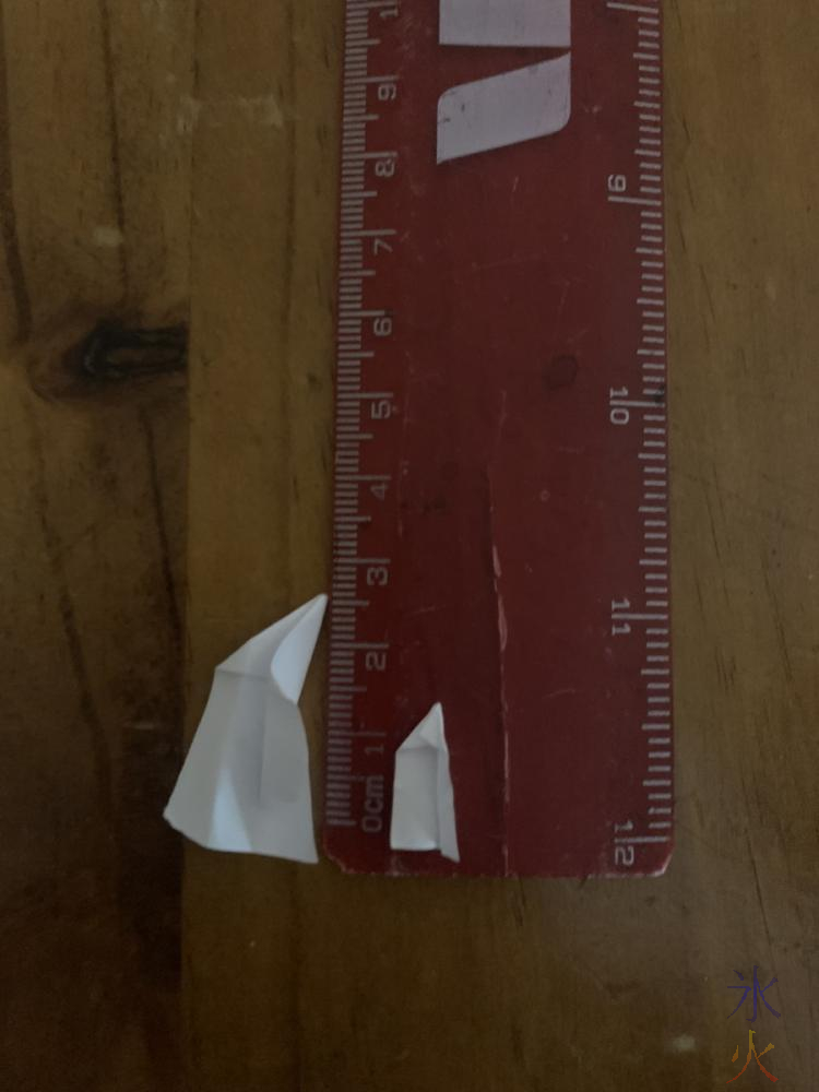 small paper planes on a ruler to show how small they are