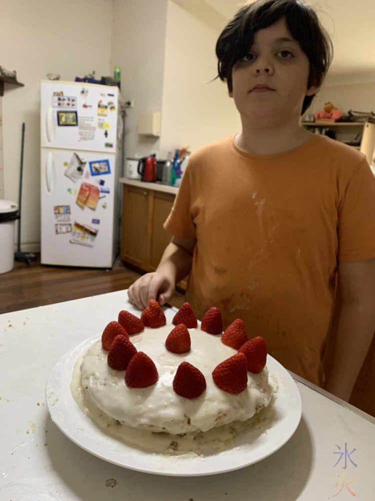 11yo with box vanilla cake topped with lemon icing and strawberries
